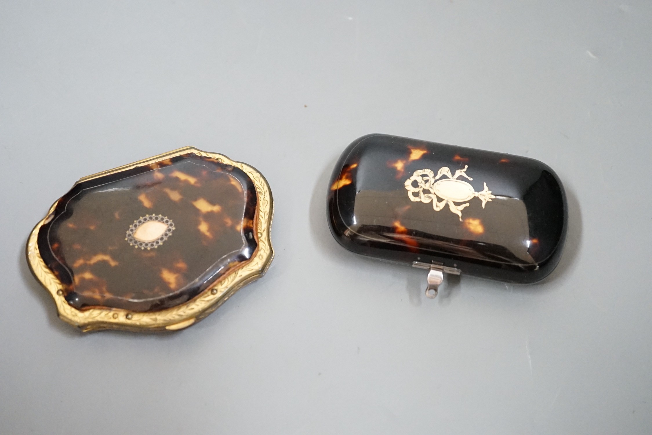 A 19th century finely worked tortoiseshell piqué work purse, with blue silk lining and a similar git metal edged piqué work purse